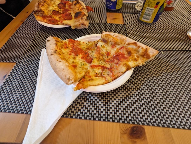 two slices of pizza on a white plate
