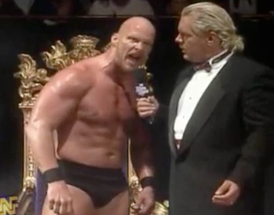 A white male wrestler named Stone Cold, wearing some black briefs and boots talking into a mic with anger. He was famous for uttering the line 'and that's the bottom line cos Stone Cold said so'